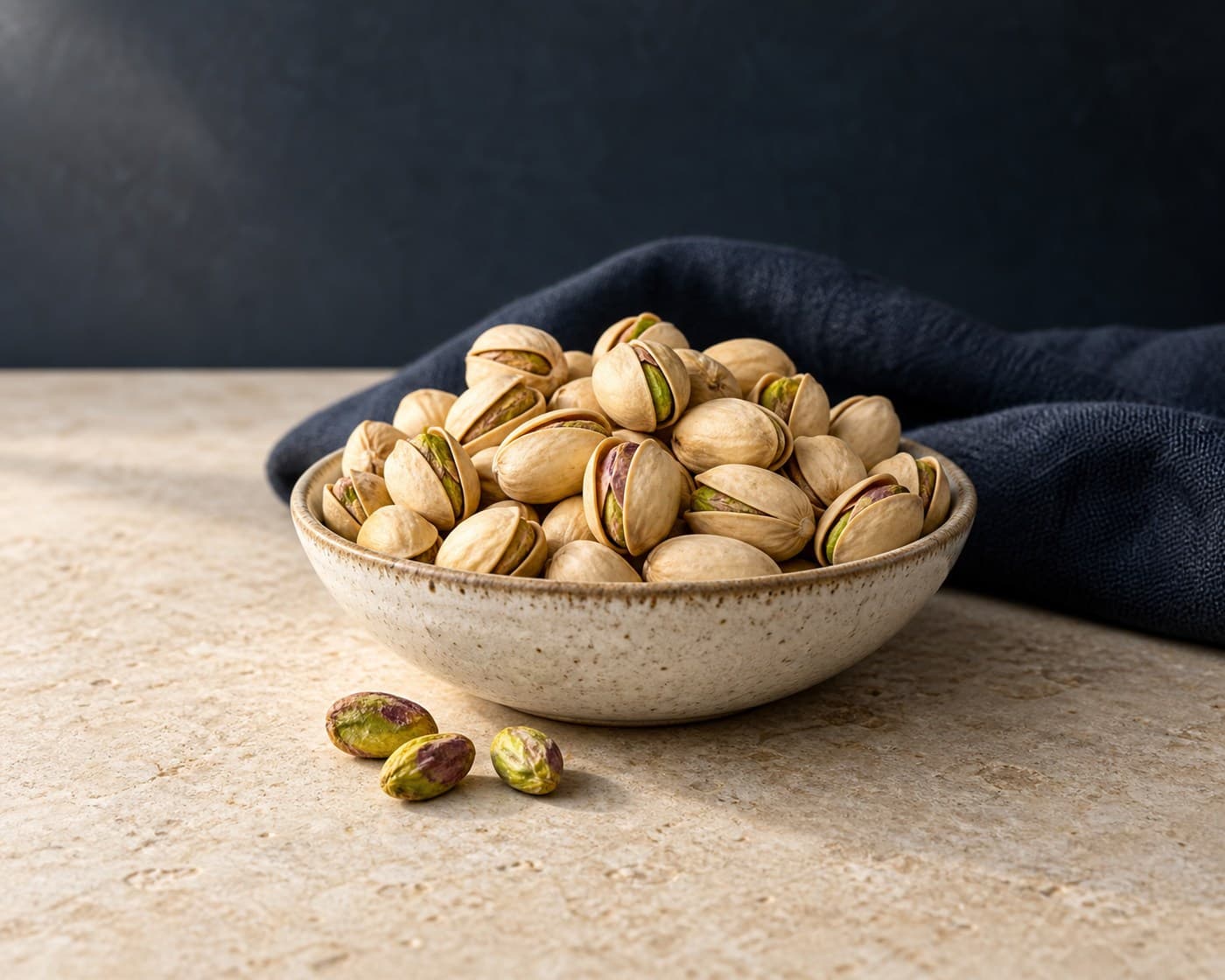 In-shell pistachios with shelled kernels in a ceramic bowl