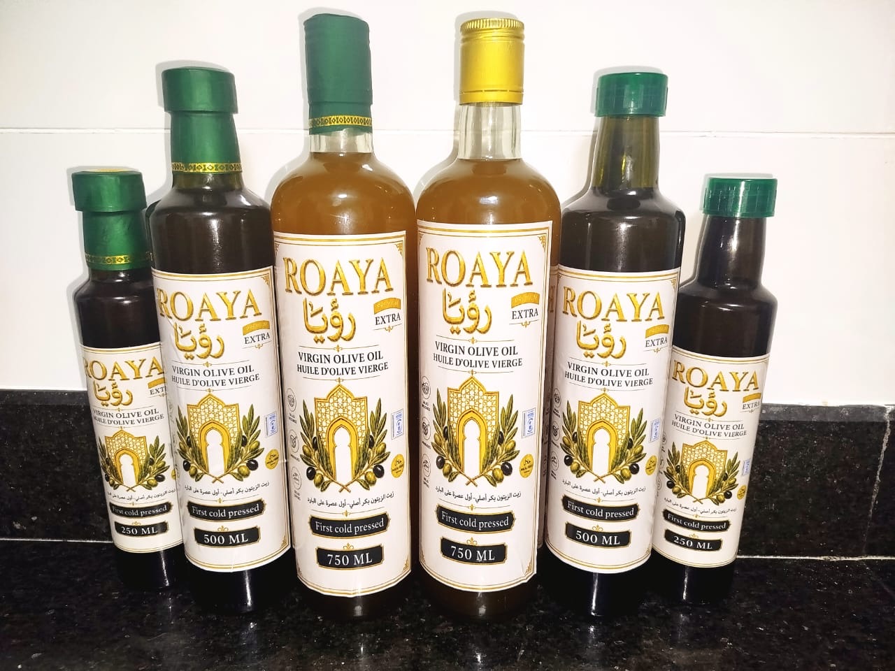 ROAYA olive oil bottles on a kitchen counter